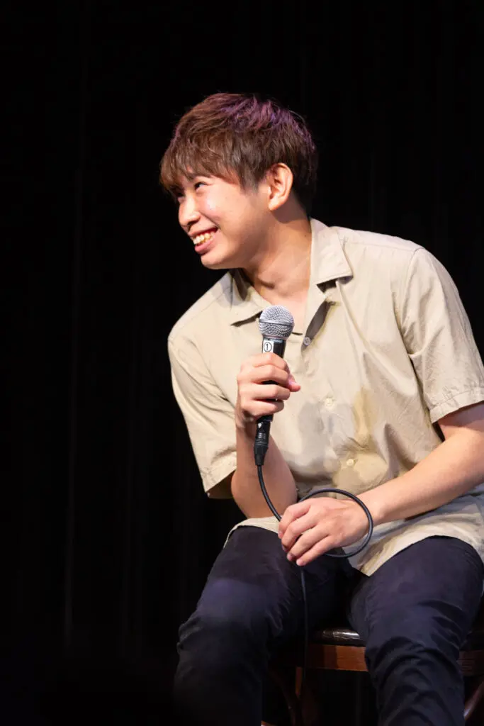 Headshot of a man speaking with audience at the Symposium for My Invincible Compass Movie - Tokyo Portrait Photographer