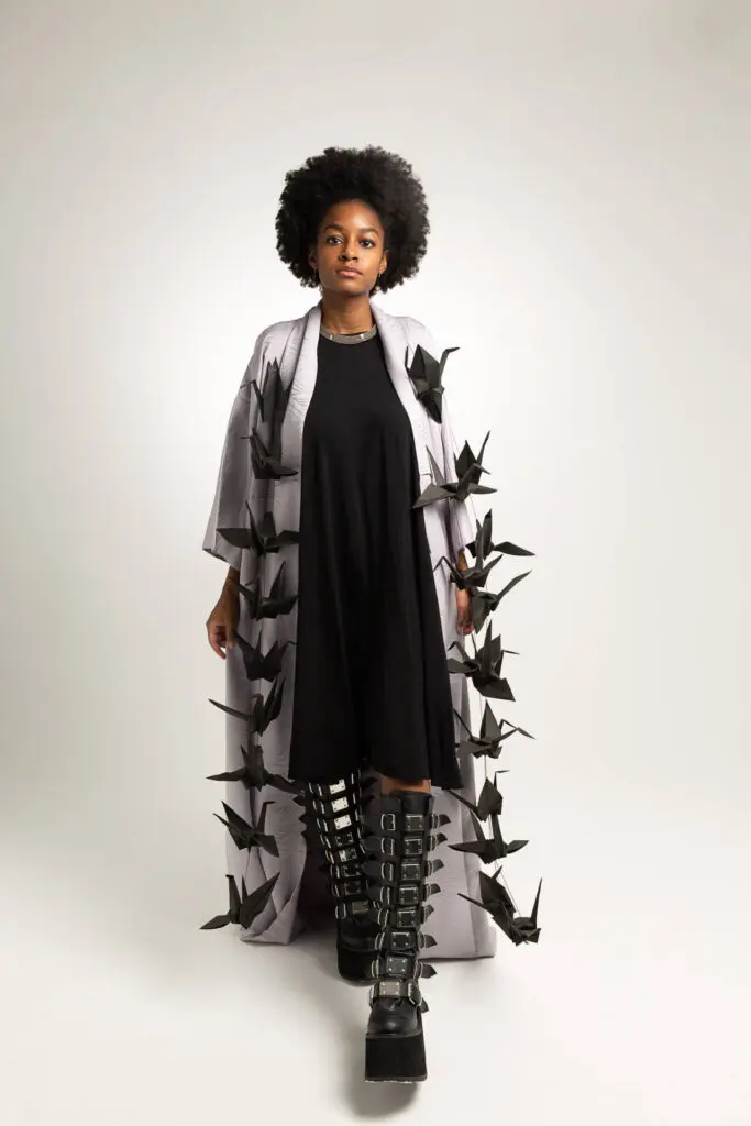 Indoor headshot of a model wearing a long shirt with many paper bats attached to it - Tokyo Portrait Photographer