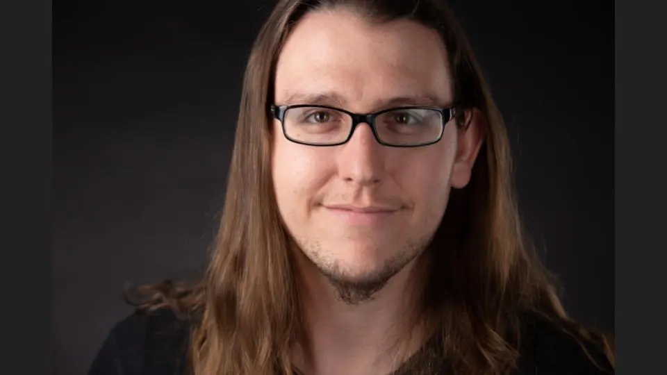 A young man with eyeglasses and long hair in a black shirt facing the camera - Tokyo Portrait Photographer, Headshot photos