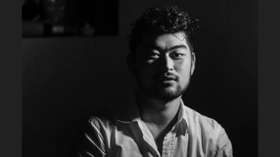 Black and white shot of a simple Japanese young man facing the camera indoors - Tokyo Portrait Photographer, Headshot photos