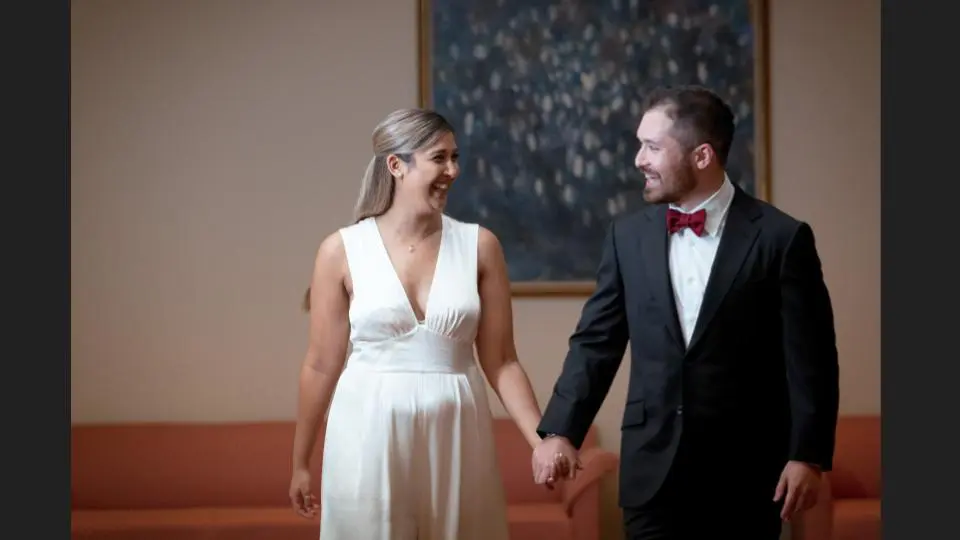 A portrait of a happy smiling couple hand-in-hand in wedding outfits - family photography, lifestyle photography