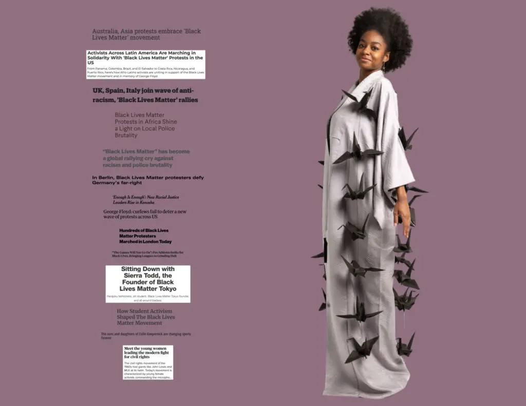 A female model in a long flowing white dress with many black paper bats on her dress - Tokyo Portrait Photographer