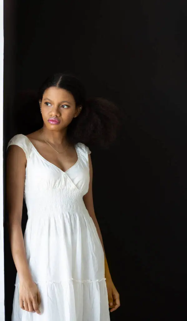 A beautiful young woman in a white top standing with the wall looking away - Tokyo Portrait Photographer, Headshot photos