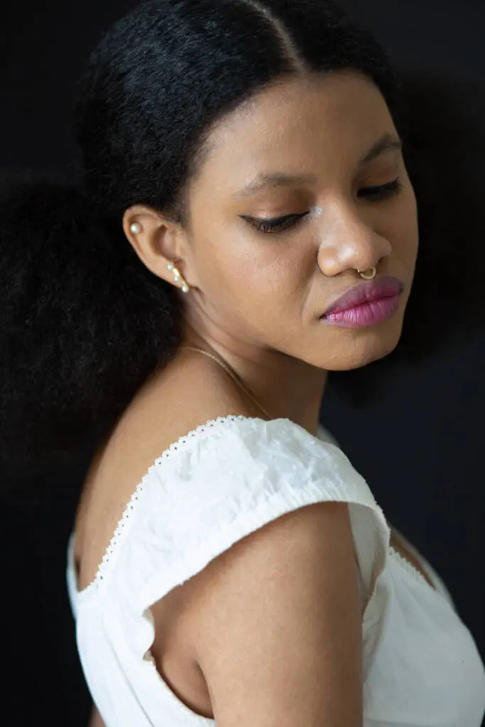 A closeup eyes-down shot of a woman in a white dress wearing septum piercing - Tokyo Portrait Photographer, Headshot photos