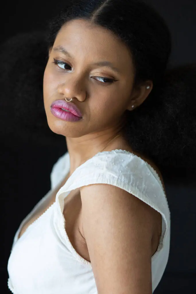 A closeup no-look shot of a woman in a white dress wearing septum piercing - Tokyo Portrait Photographer, Headshot photos