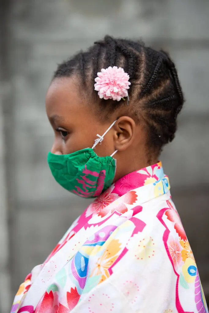 A little girl with dreadlocks and a face mask, wearing a multi color shirt - Tokyo Portrait Photographer, Headshot photos