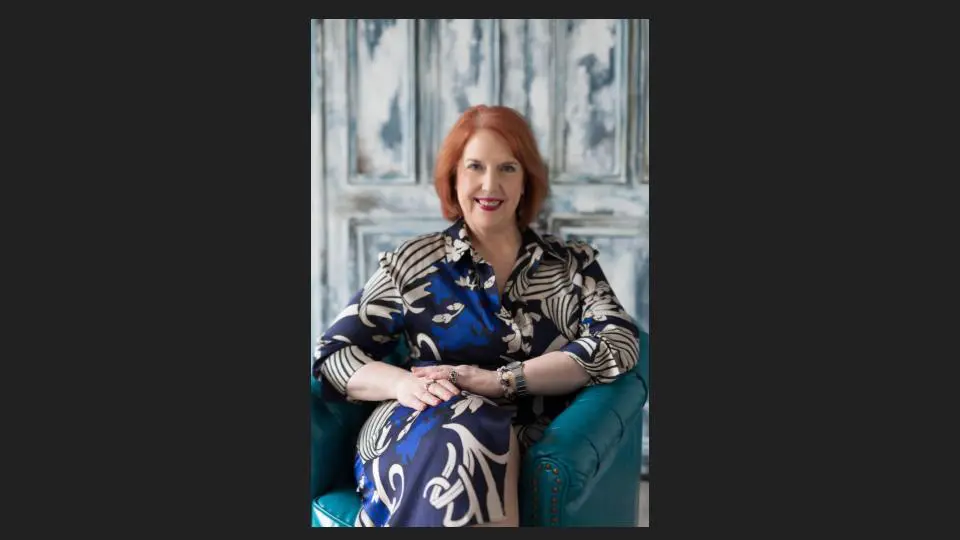An elderly woman in a multi-color dress sitting on a sofa, and smiling - Tokyo Portrait Photographer, Headshot photos