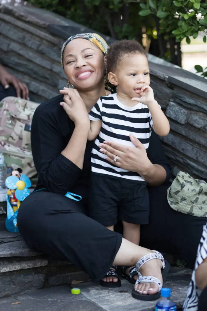A young mother sitting on some stairs with her little boy in her arms - Tokyo Portrait Photographer, family photography
