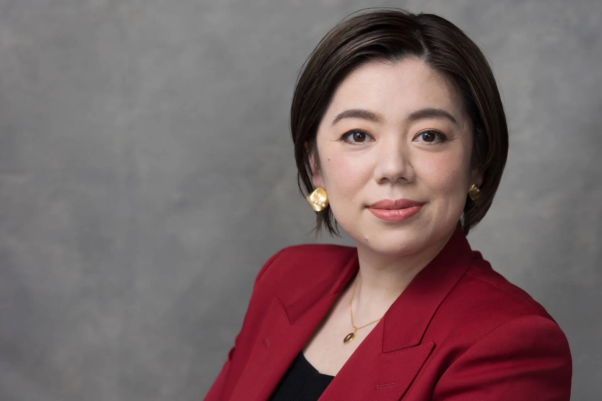 Clear Headshot of a professional mature woman in a red suit coat facing the camera - Charlotte Portrait Photographer