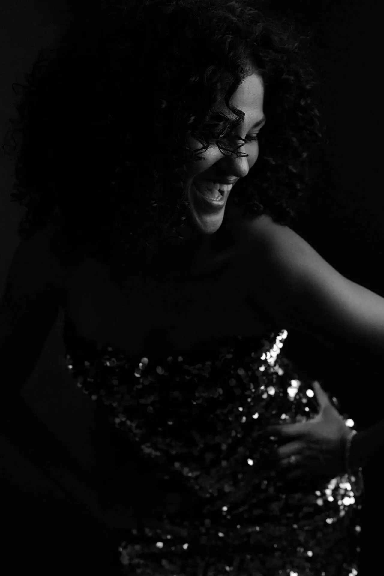 Black and white portrait photography of a woman smiling while dancing in her glittering sequined dress - Photographer in Tokyo, Tokyo Portrait Photographer, Photographer in Tokyo