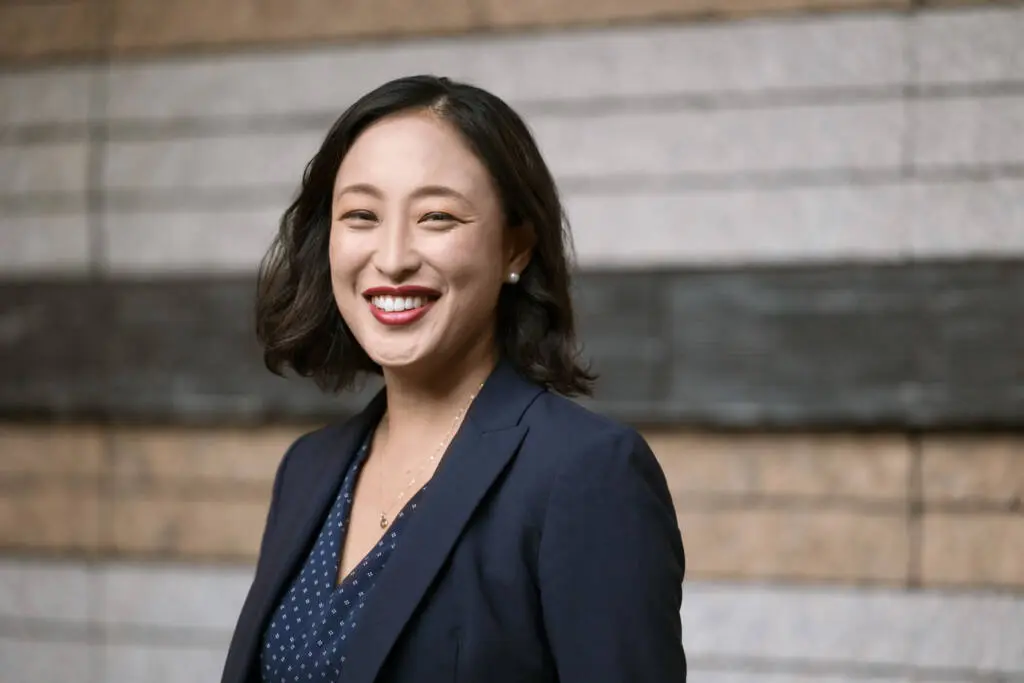Headshot of a smiling Japanese woman in a blue suit at a corporate office event - Headshot photos, Tokyo Event Photography