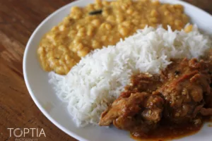 Close-up of a comforting meal with rice, lentils, and curry, capturing warmth and home-style flavor. Photo by Tia Haygood.