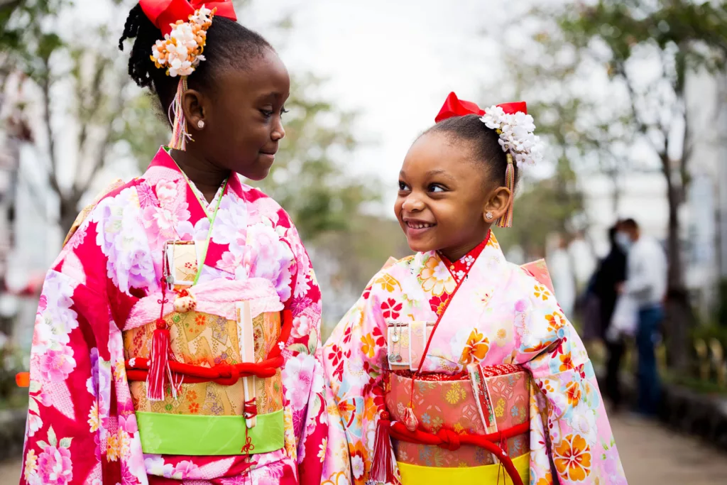 Two young little girls in Japanese cultural festive outfits walking together - family photography, Japan Photography