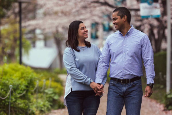 A young couple, both wearing sky blue shirts and navy blue pants, smiling at each other - Tokyo Portrait Photographer