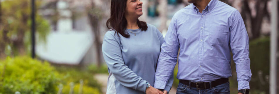 A young couple, both wearing sky blue shirts and navy blue pants, smiling at each other - Tokyo Portrait Photographer