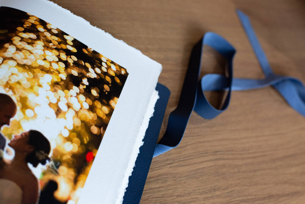 A closeup shot of a photo album placed on a table with an untied ribbon, by Toptia Photography - Tokyo Portrait Photographer