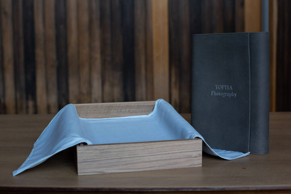 The Suede Portfolio box of Toptia Photography placed on a table along with its packaging box - Tokyo Portrait Photographer