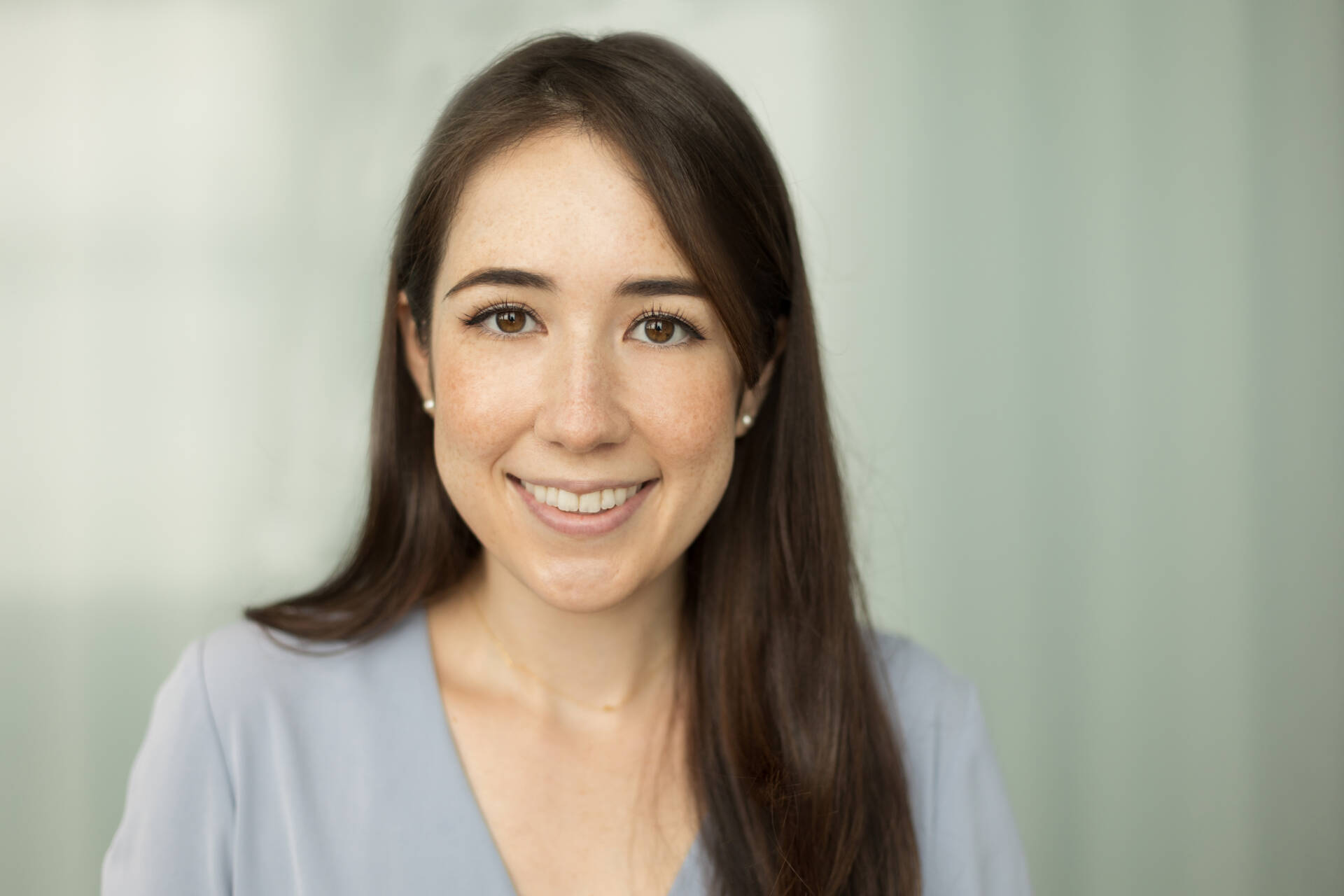 Headshot of a young woman in a grey shirt smiling at the camera - Tokyo Portrait Photographer, Headshot photos