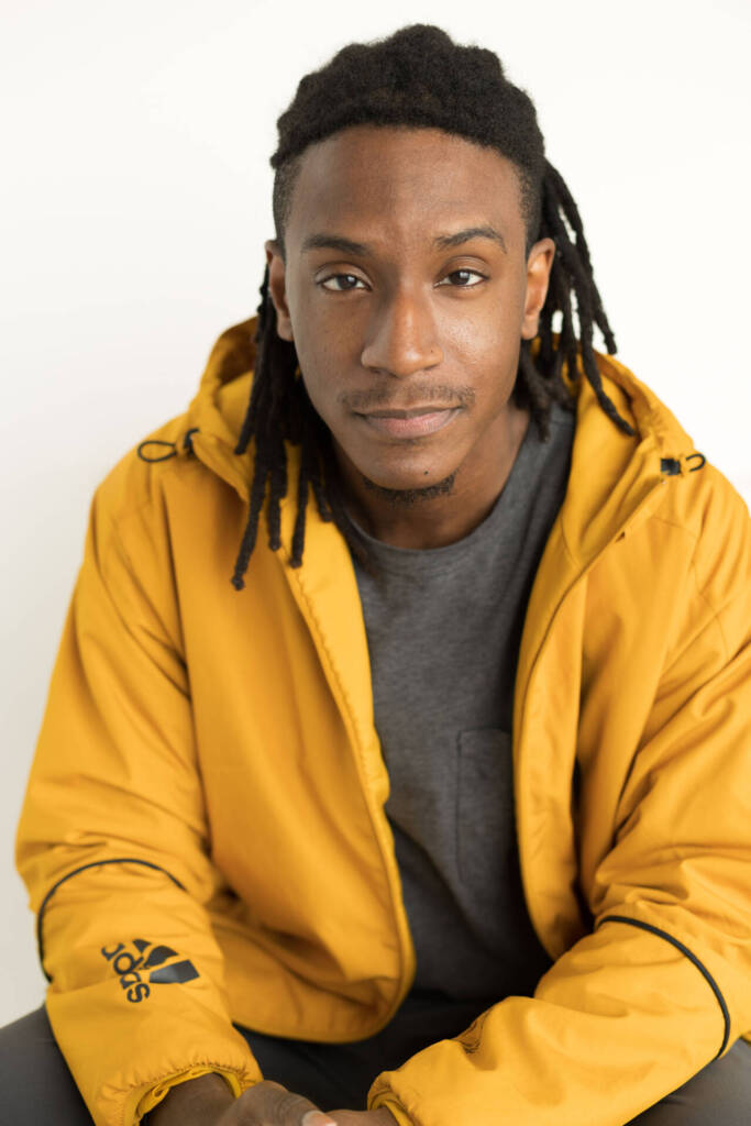 Headshot of a young man with a braided hairstyle, in a yellow jacket - lifestyle photography, Tokyo Portrait Photographer