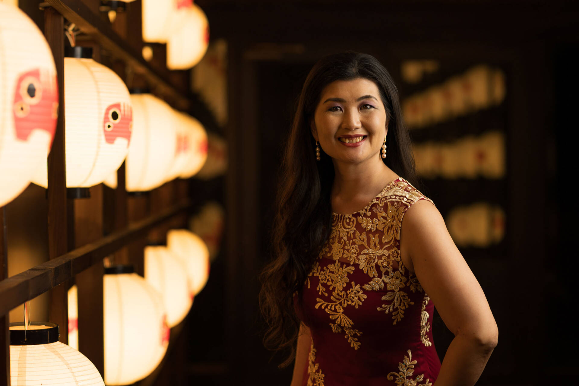 Beautiful shot of a young smiling woman wearing a Georgette Designer Palazzo Suit in red - Charlotte portrait photographer, Tokyo Portrait Photographer, Photographer in Tokyo