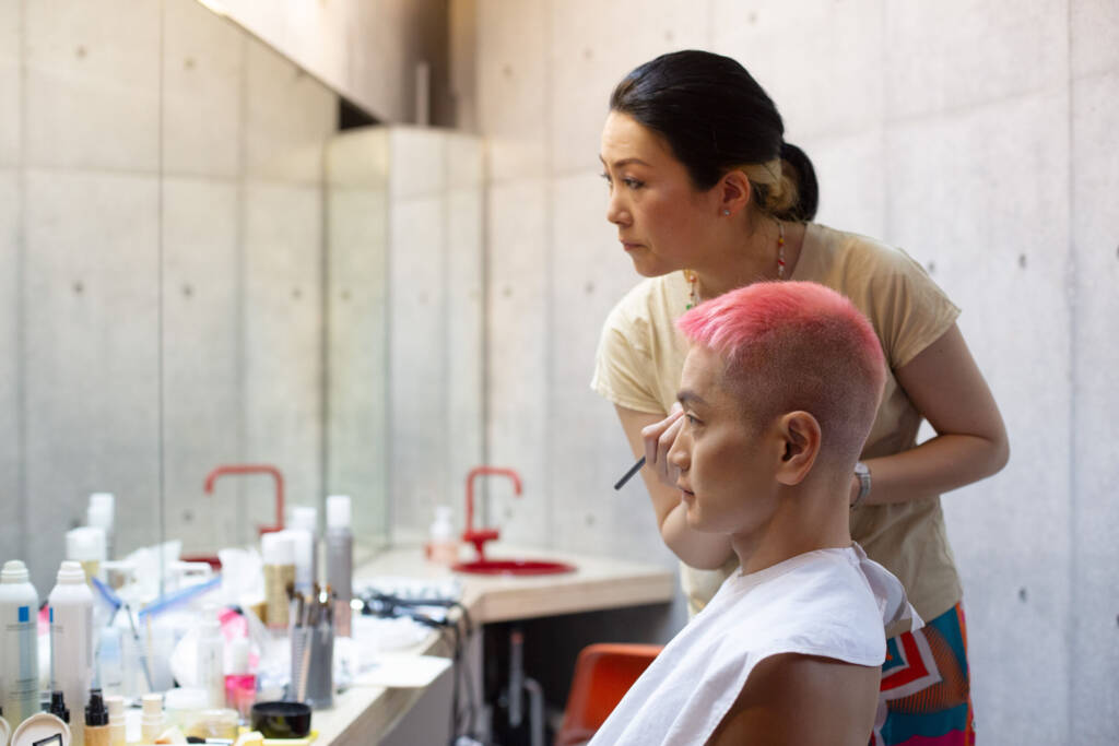 Portrait of a hairstylist working on a client's hair in a salon, facing the front mirror - Tokyo Portrait Photographer