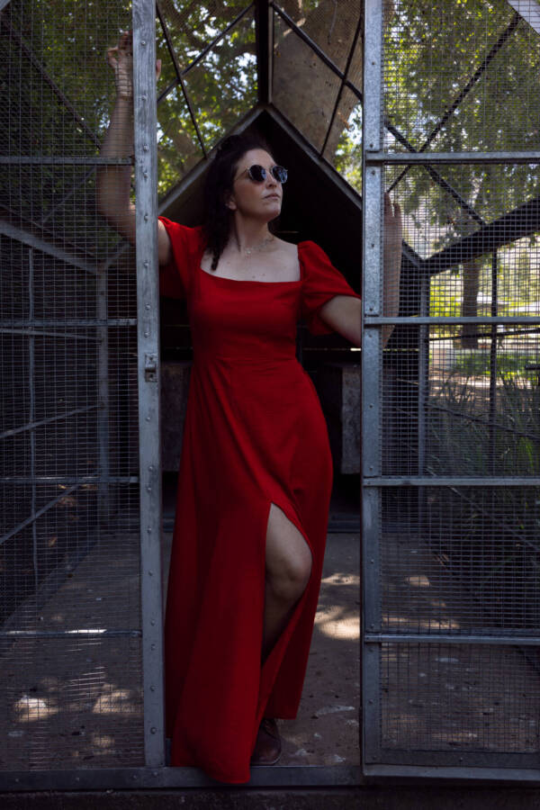 Stylish model in a dark red dress posing with a cage door inside a park - Tokyo Portrait Photographer, Photographer in Tokyo