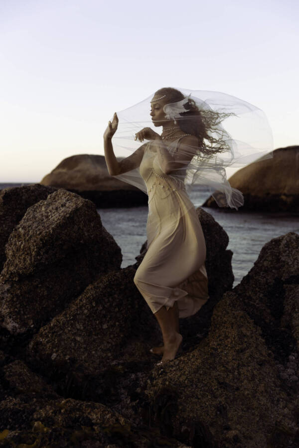 Beautiful bride standing on big stones at a beach in a fancy bridal gown - Tokyo Portrait Photographer, Japan Photography