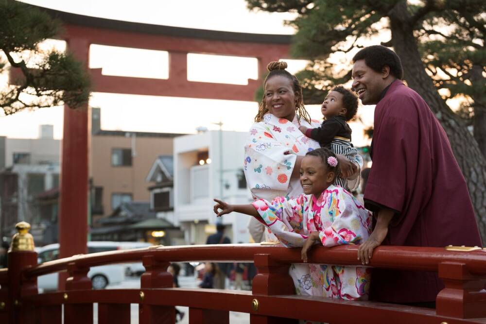 Portrait of a young family with two kids and parents in a family park - family photography, lifestyle photography