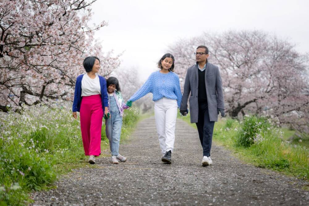 A randomly clicked portrait of a family of four in a greenery area - family photography, lifestyle photography