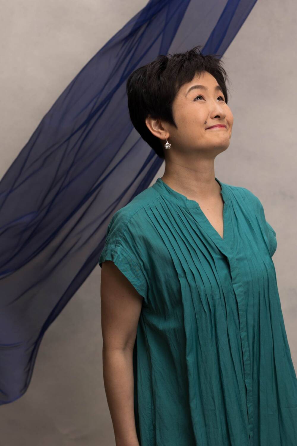 Woman in her 40's minimalistic casual shot on a blue fabric backdrop - Casual wear portraits