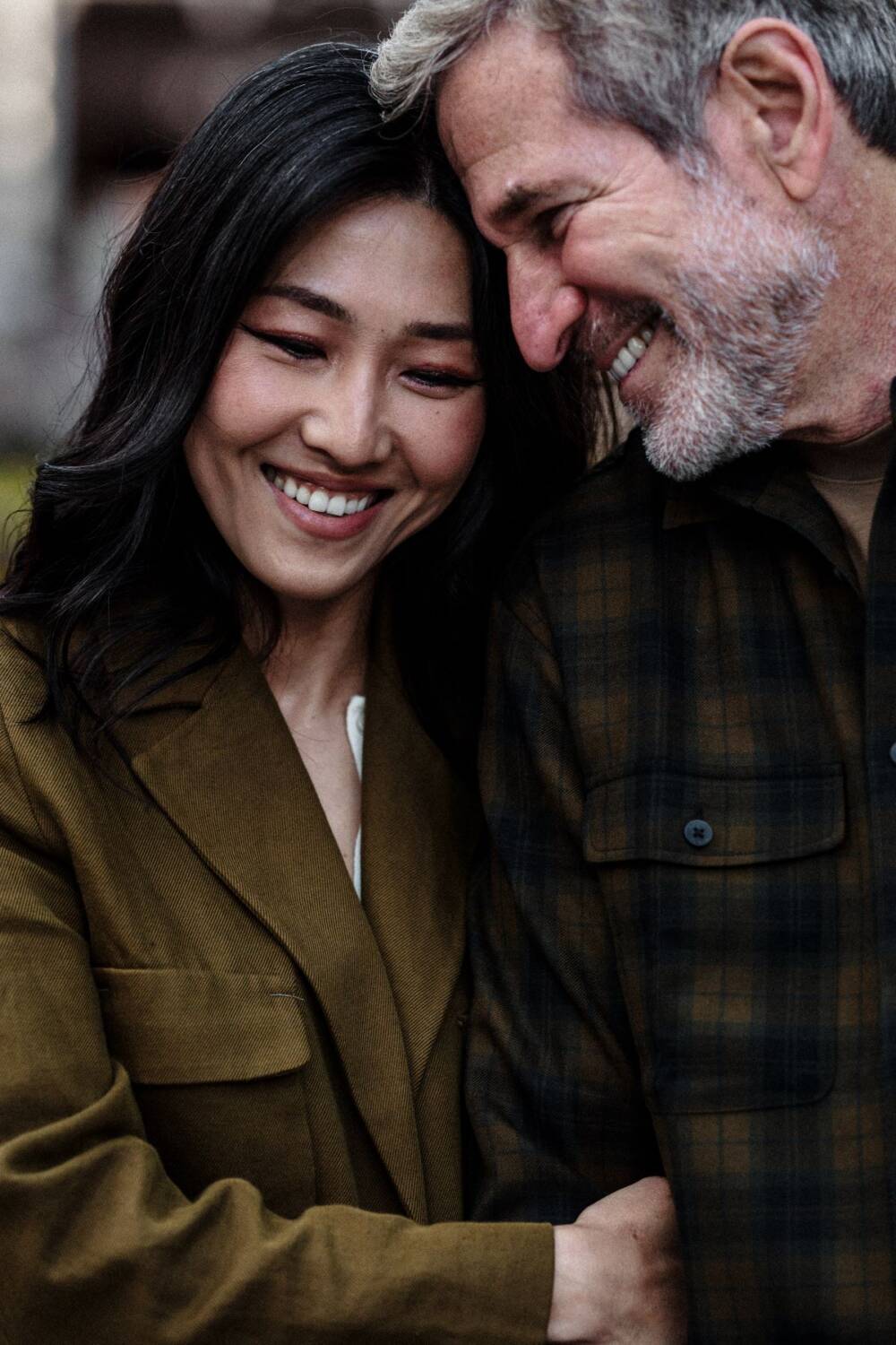 Happy couple in casual outfits, smiling at each other - Couple portraits on deep contrast, Tokyo Portrait Photographer