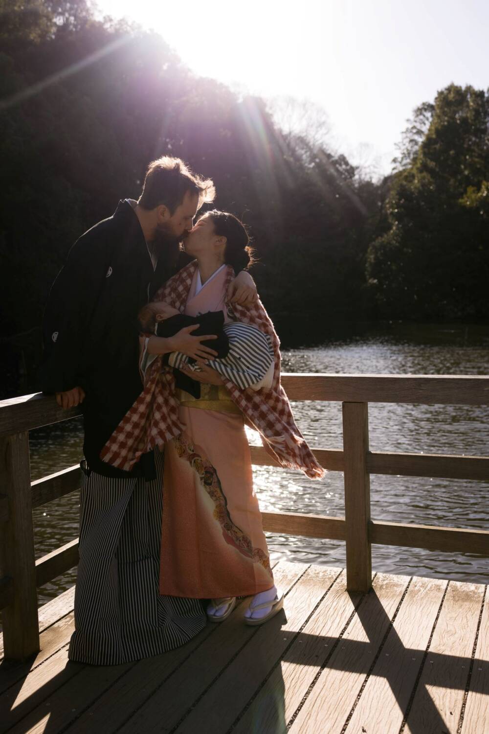 Happy family wearing kimonos, lake backdrop nature-inspired family photography - Tokyo portrait photographer