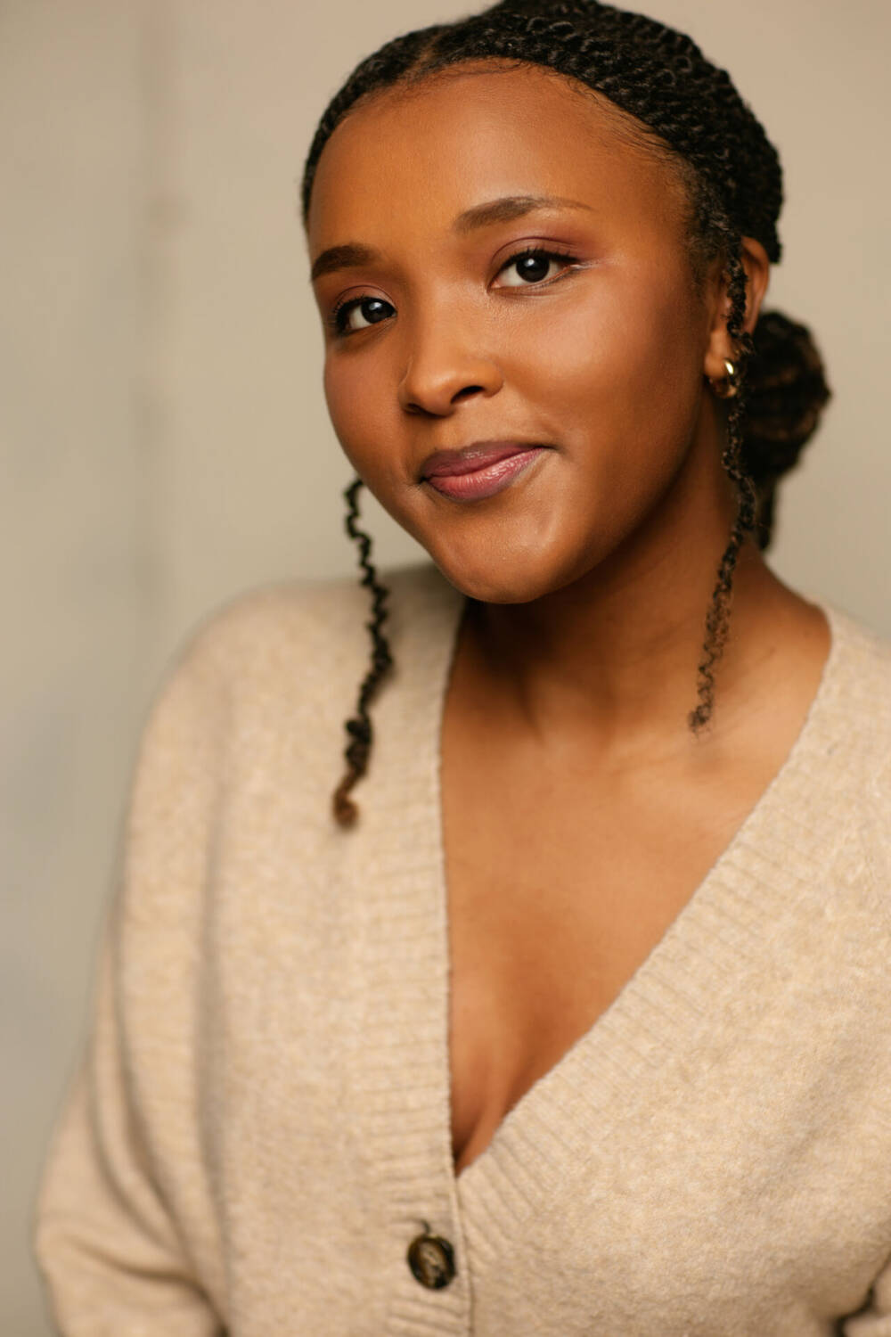 Beautiful woman wearing a cardigan with short-braided hair, simple portrait photography