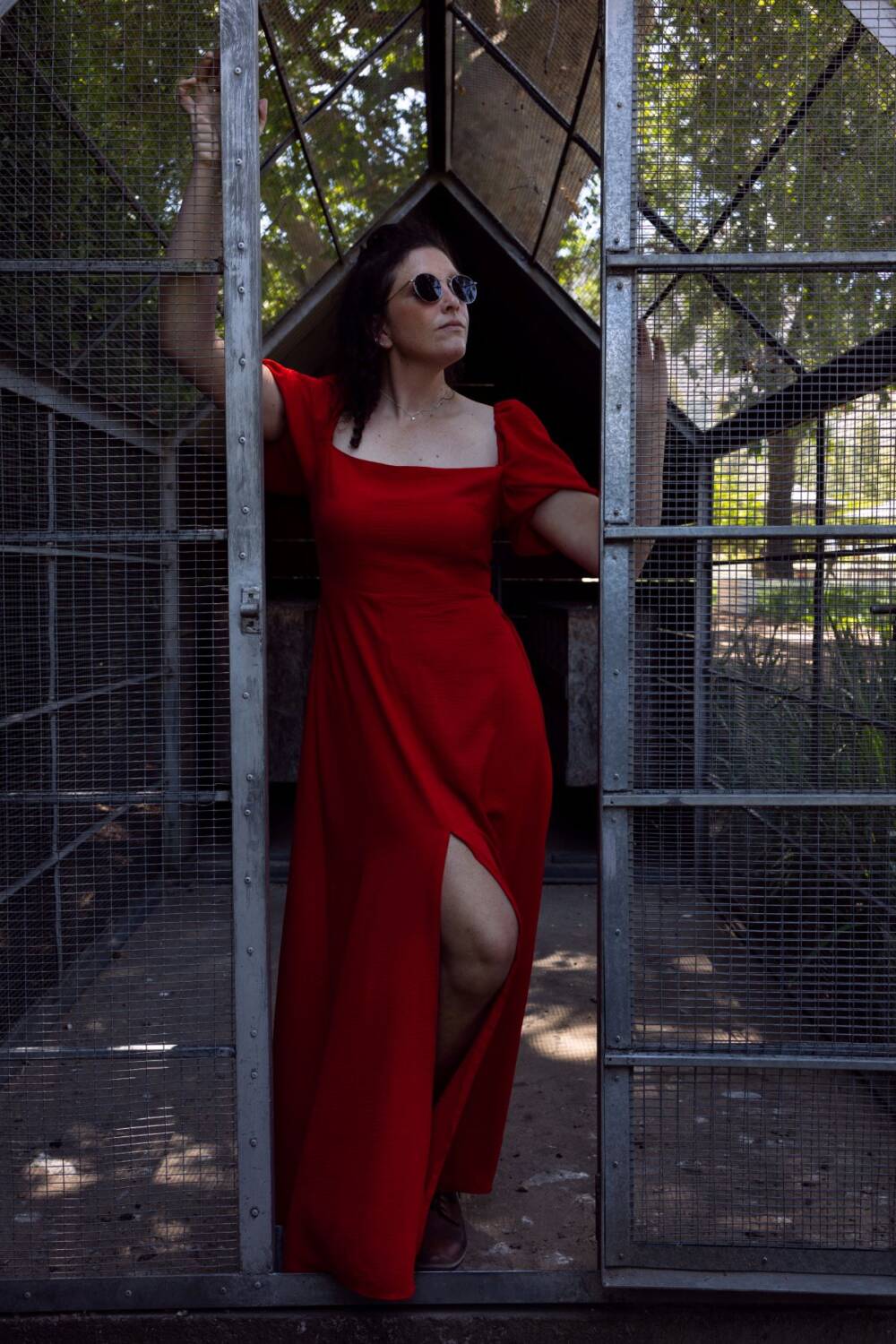 Stylish model in a dark red dress posing with a cage door inside a park - Tokyo Portrait Photographer, Photographer in Tokyo