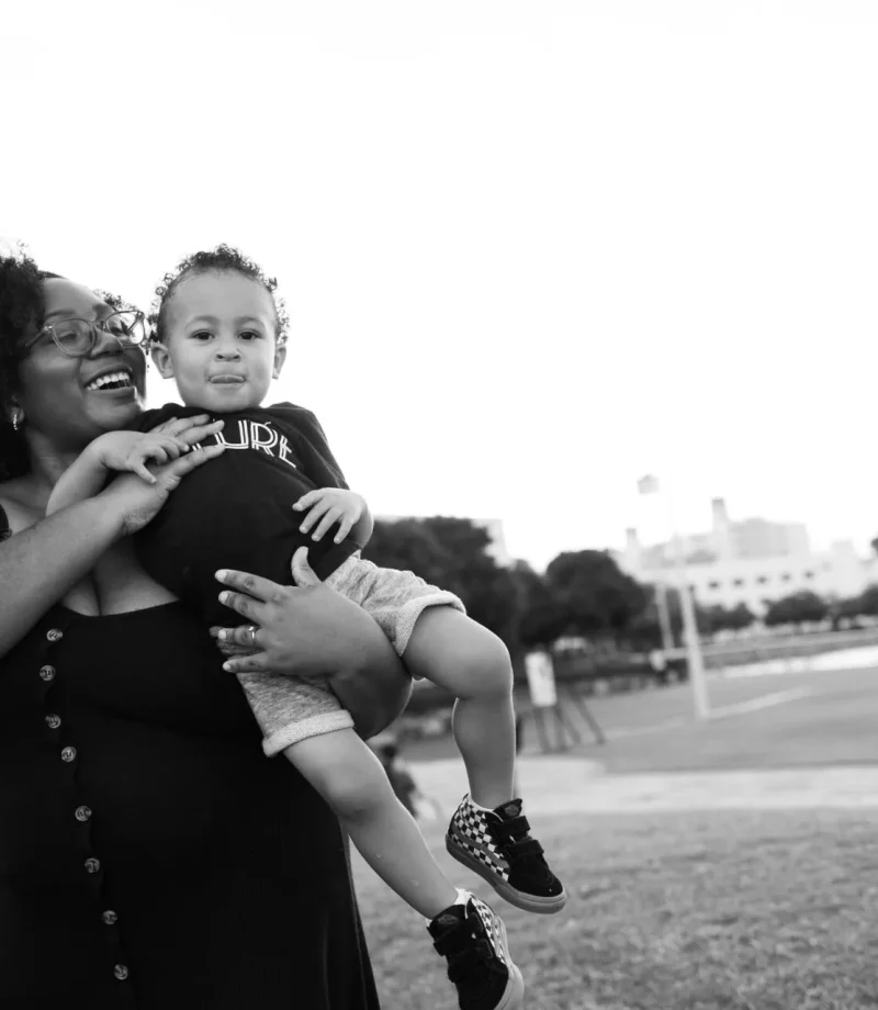 Black and white shot of a woman with her little boy raised in her hands - Tokyo Portrait Photographer, family photography