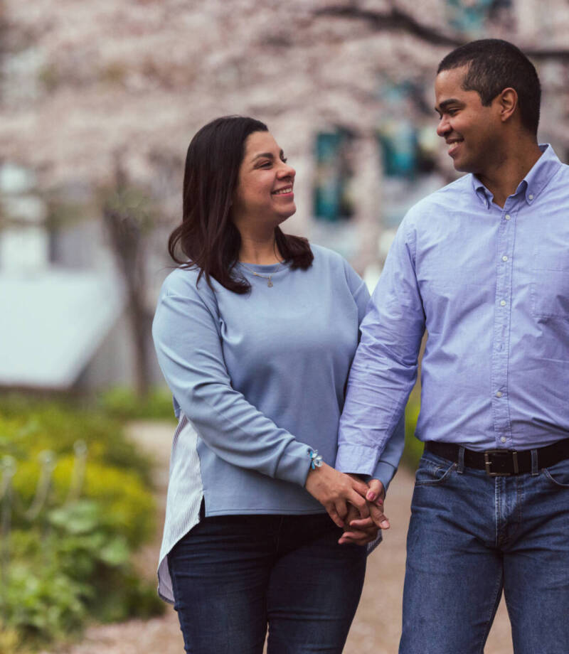 A young couple, both wearing sky blue shirts and navy blue pants, smiling at each other - Tokyo Portrait Photographer