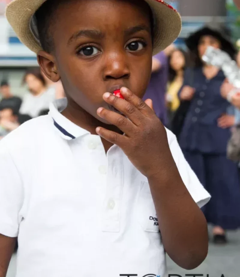 A closeup shot of a kid with a floppy hat eating candy and facing the camera - Tokyo Portrait Photographer, Headshot photos